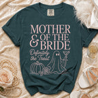 Teal t-shirt with "Mother of the Bride Definitely the Treat" in pink text.