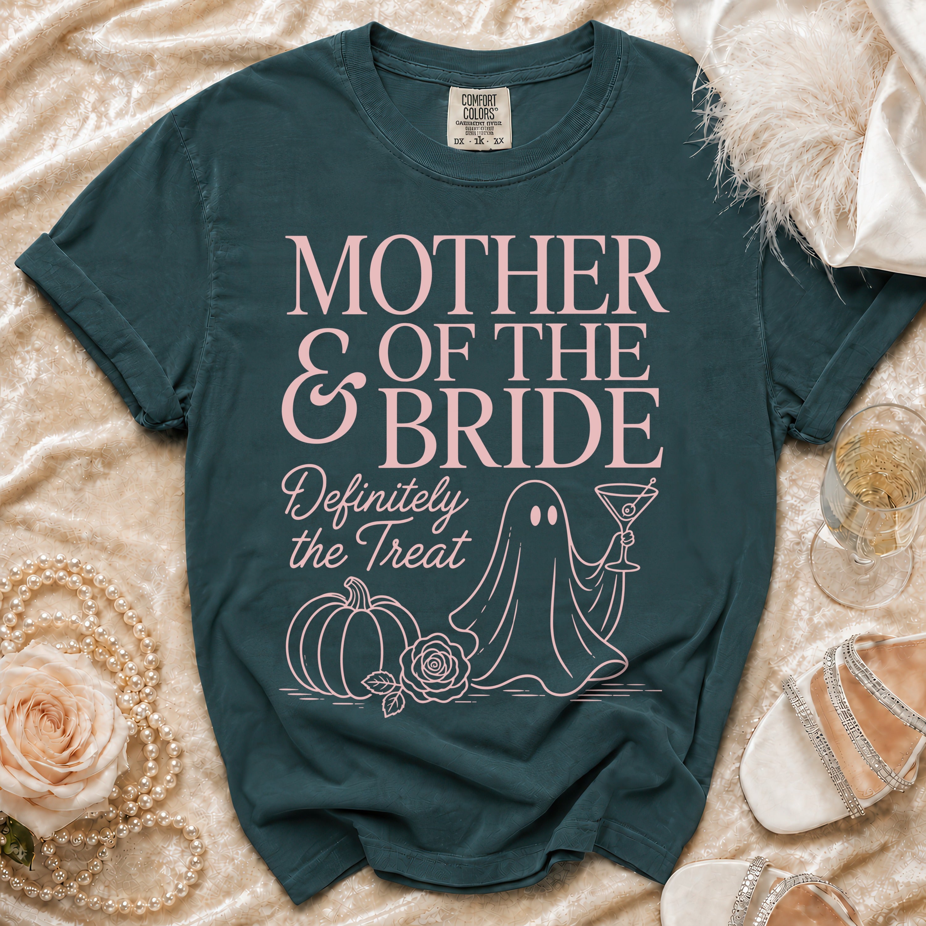 Teal t-shirt with "Mother of the Bride Definitely the Treat" in pink text.