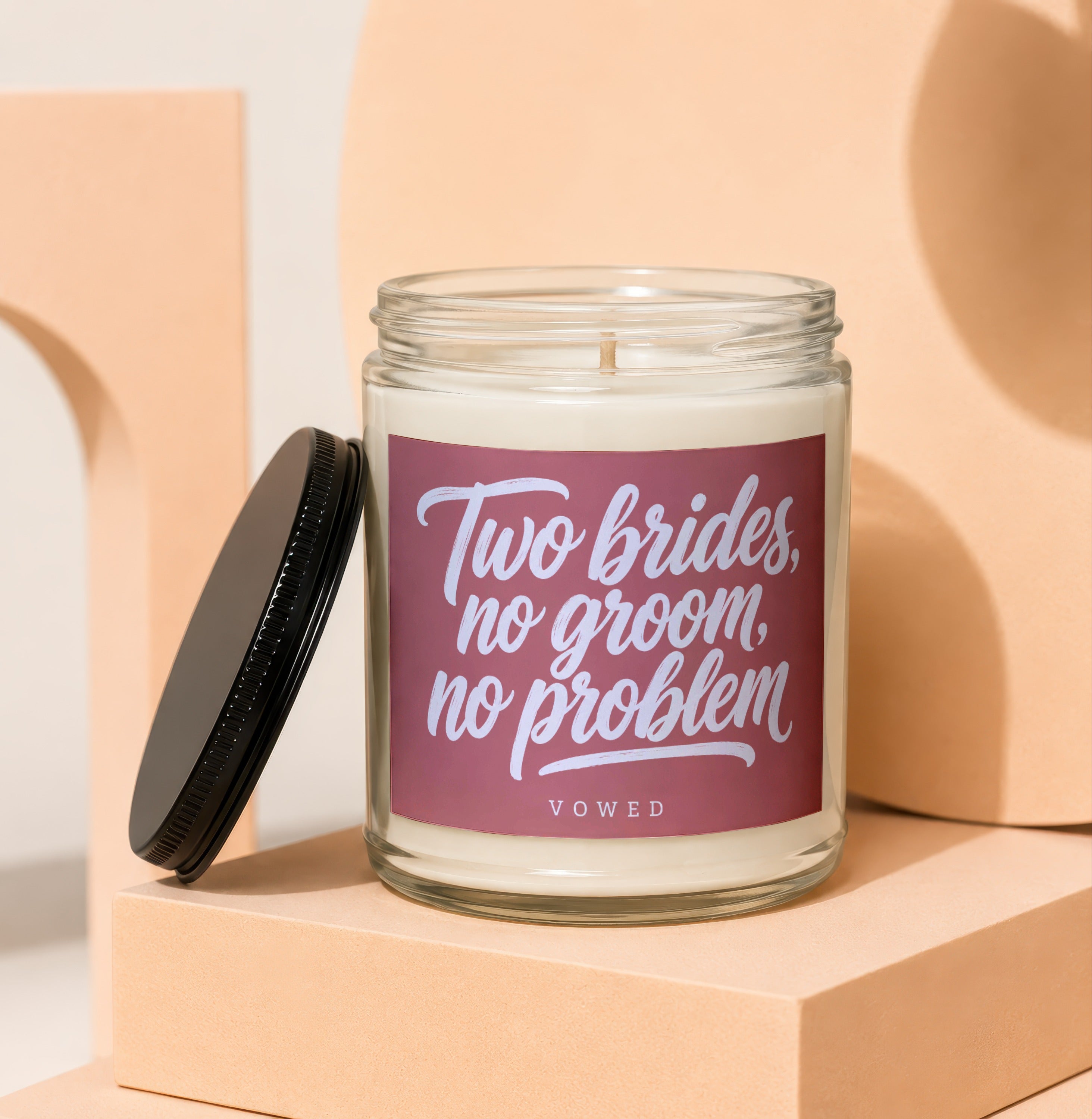 Candle with text "Two brides, no groom, no problem" and "VOWED".