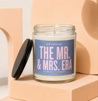 Candle with "The Mr. & Mrs. Era" text and a black lid.
