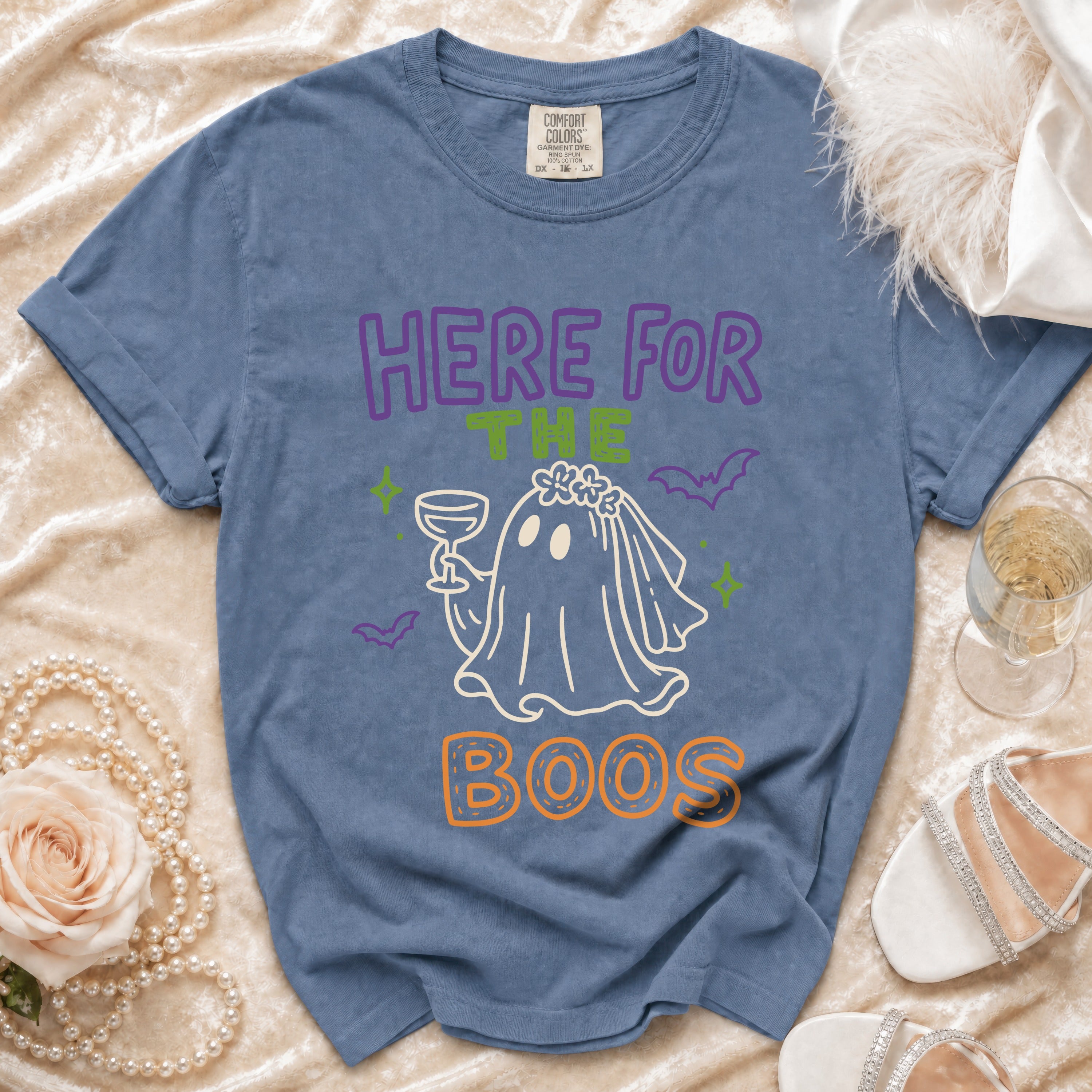 Blue t-shirt with "HERE FOR THE BOOS" ghost graphic and Comfort Colors tag.