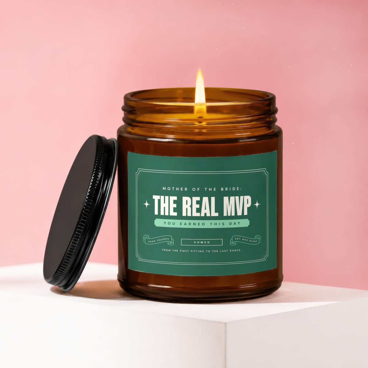 Amber jar candle with lit flame, "The Real MVP" label for Mother of the Bride.