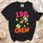 Black t-shirt with "I DO CREW" text, champagne bottle, and stars graphic.