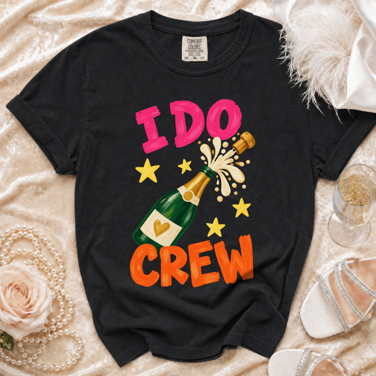 Black t-shirt with "I DO CREW" text, champagne bottle, and stars graphic.