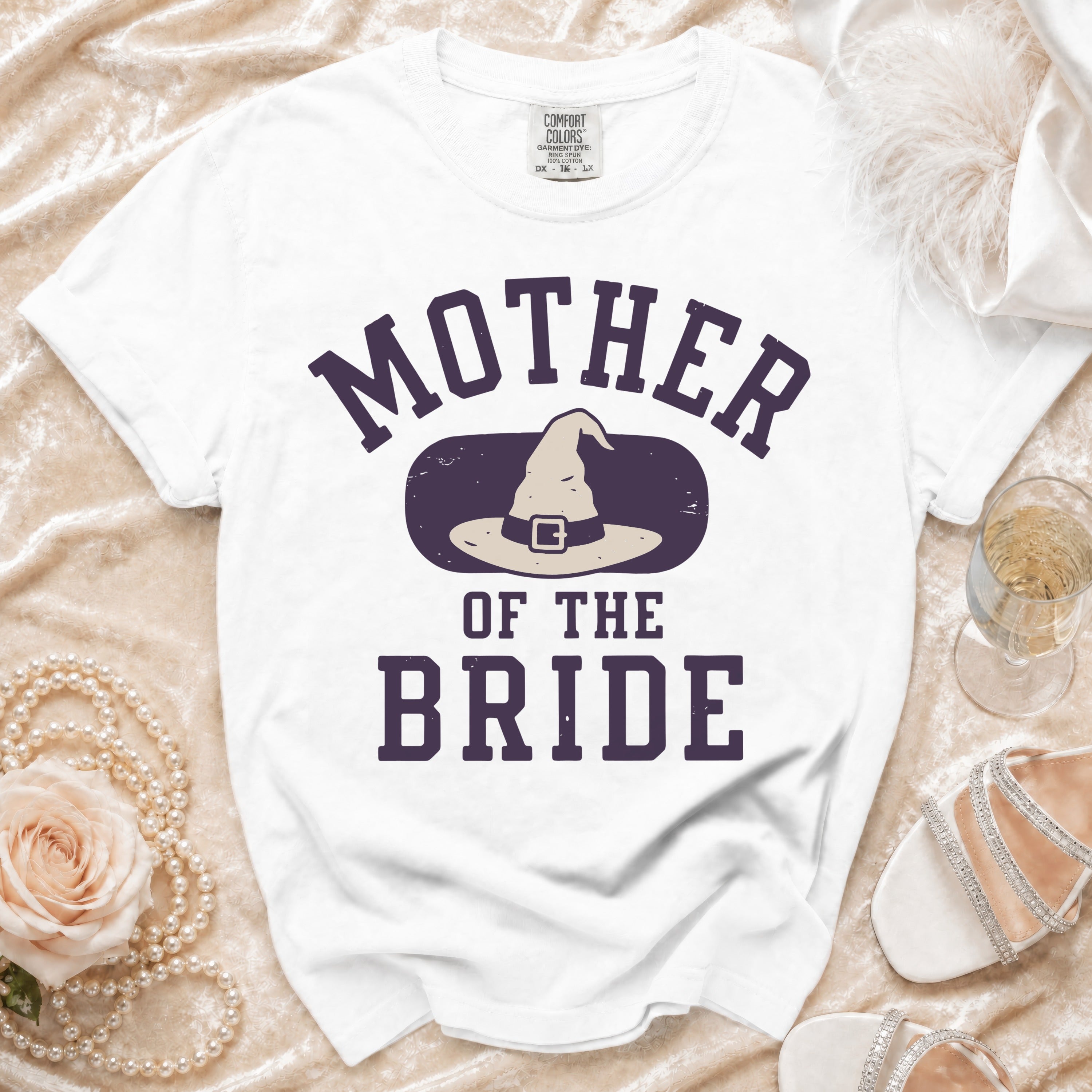 White t-shirt with "Mother of the Bride" and a witch hat graphic.