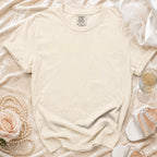 Comfort Colors t-shirt with "Olivia's Back" text on a cream background.