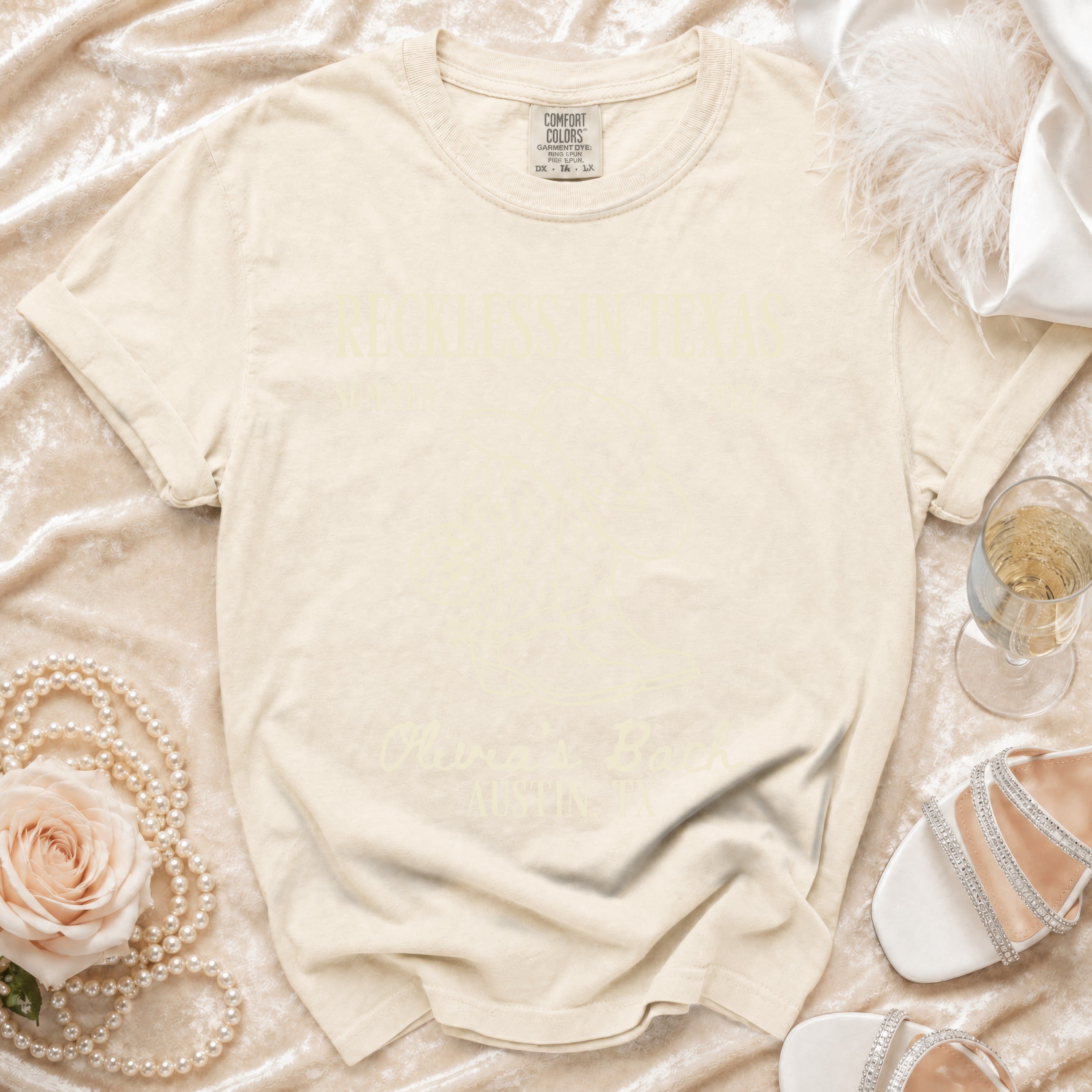 Comfort Colors t-shirt with "Olivia's Back" text on a cream background.