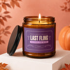 Amber jar candle with purple label that reads "Last Fling Before the Ring".