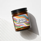 Amber candle in jar with "Be Still, My Heart! You're Engaged!" text and wavy colorful label.