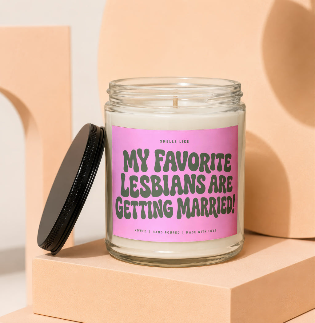 Candle with pink label text "My Favorite Lesbians Are Getting Married!".