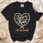 Black Comfort Colors shirt with "Tying the Knot with my Cowboy" graphic.