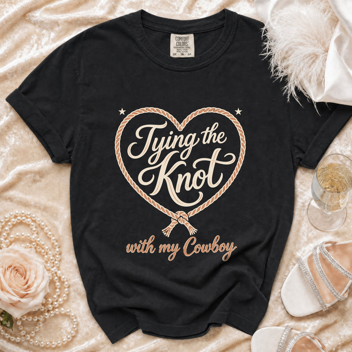 Black Comfort Colors shirt with "Tying the Knot with my Cowboy" graphic.
