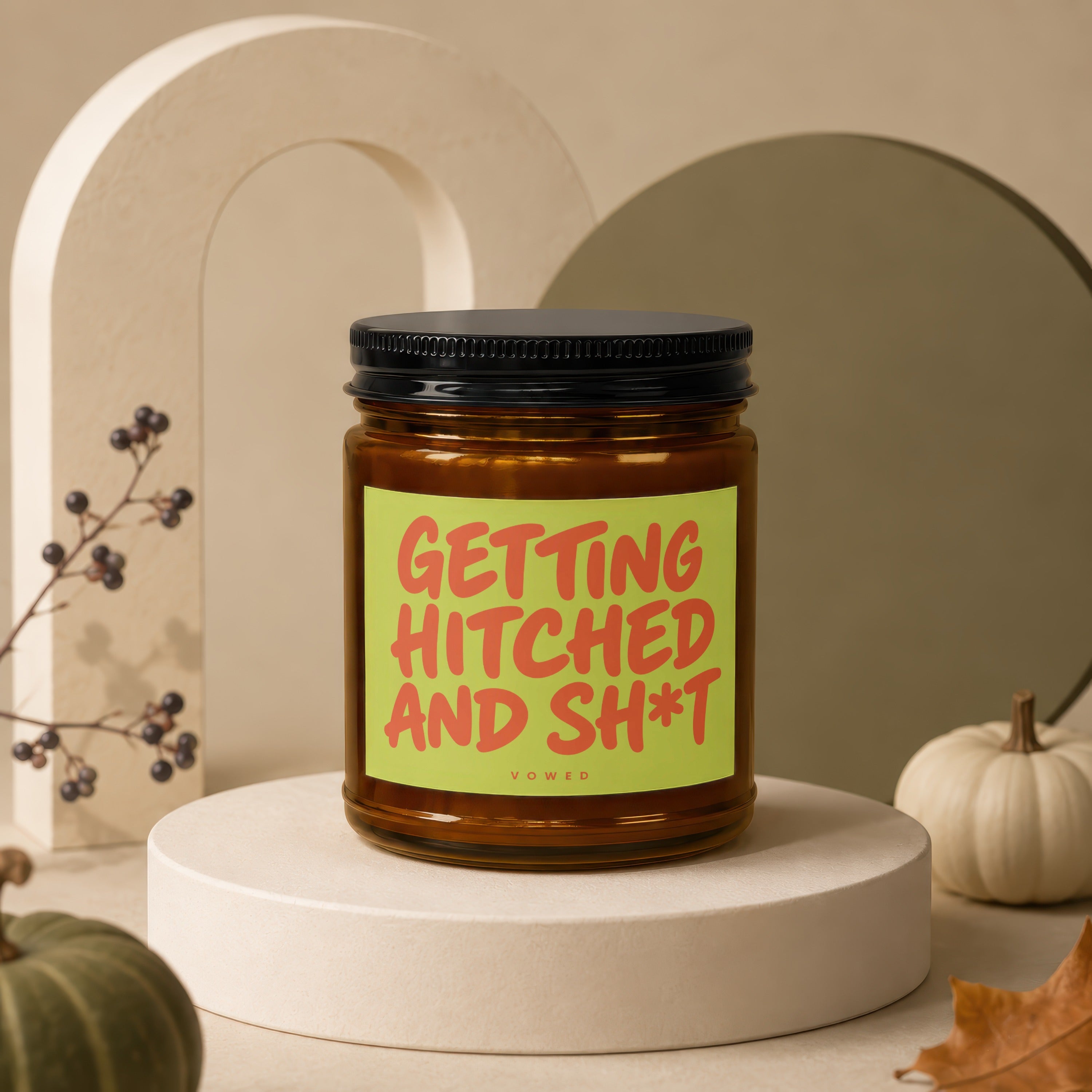 Amber jar candle with a lime green label reading "GETTING HITCHED AND SH*T" and "VOWED".