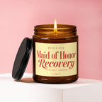 Amber candle with lit flame, black lid nearby, reading "Maid of Honor Recovery".