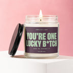 Candle with label reading "Smells like You're One Lucky B*tch. And He Knows It. Vowed."