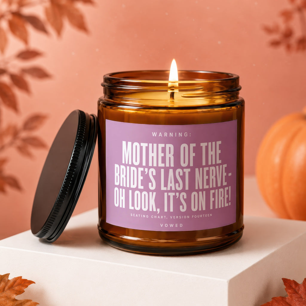 Amber candle with lit wick, reads "Mother of the bride's last nerve- oh look, it's on fire!"