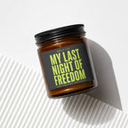 Brown amber glass candle with black lid and "My Last Night of Freedom" label.