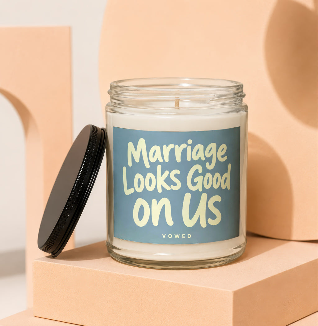 Glass candle with blue label reading "Marriage Looks Good on Us".