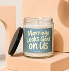Glass candle with blue label reading "Marriage Looks Good on Us".