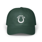 Dark green baseball cap with a white embroidered horseshoe and the text SADDLIN' UP.