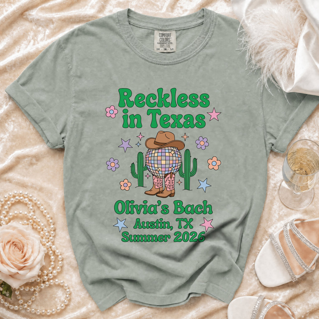 Green t-shirt with "Reckless in Texas" and "Olivia's Bach Austin, TX Summer 2026".