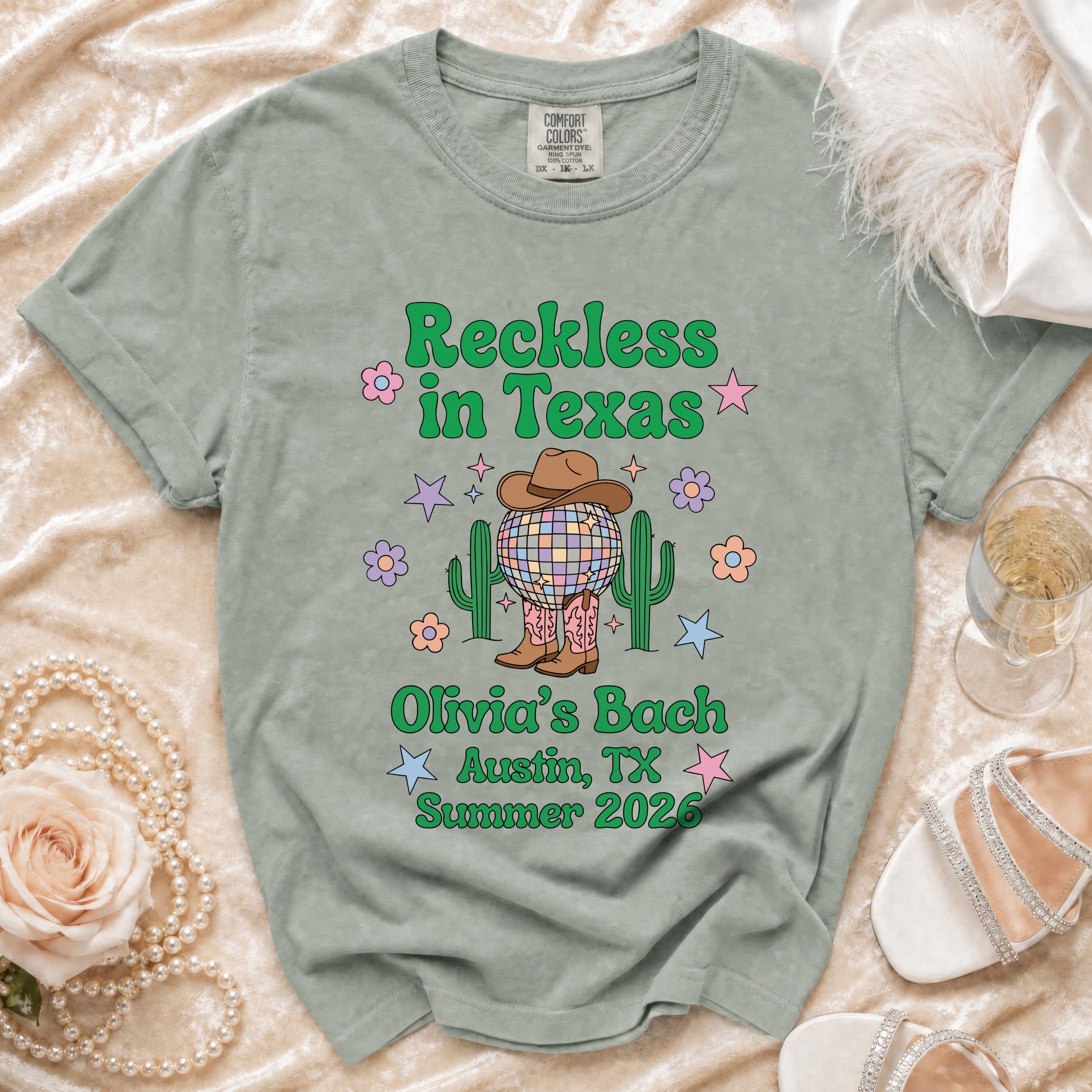 Green t-shirt with "Reckless in Texas" and "Olivia's Bach Austin, TX Summer 2026".