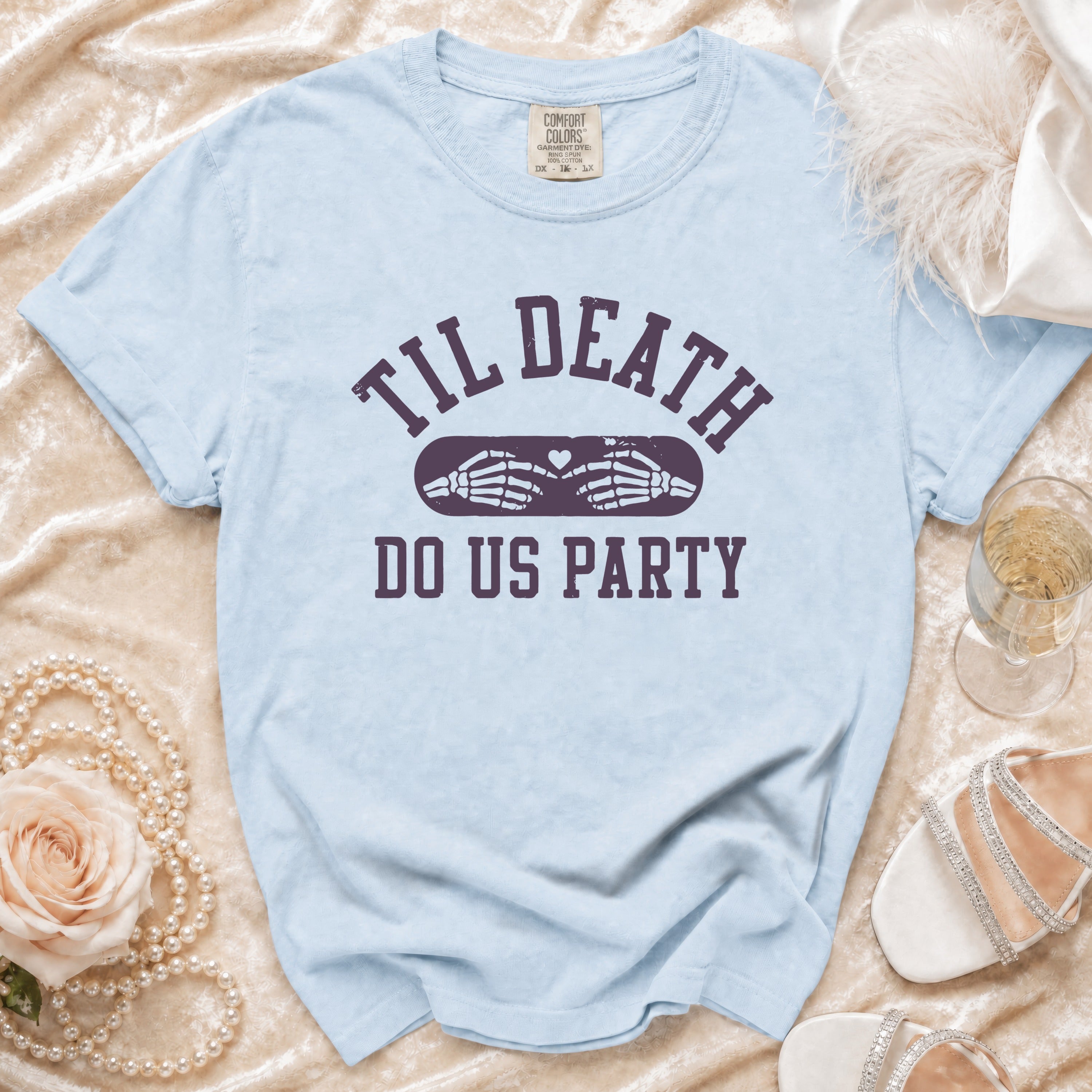 Light blue t-shirt with "Til Death Do Us Party" graphic and skeleton hands.