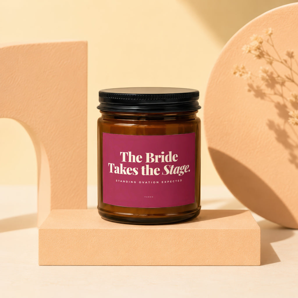 Amber jar candle with "The Bride Takes the Stage. Standing Ovation Expected" label.