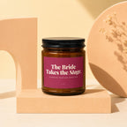 Amber jar candle with "The Bride Takes the Stage. Standing Ovation Expected" label.