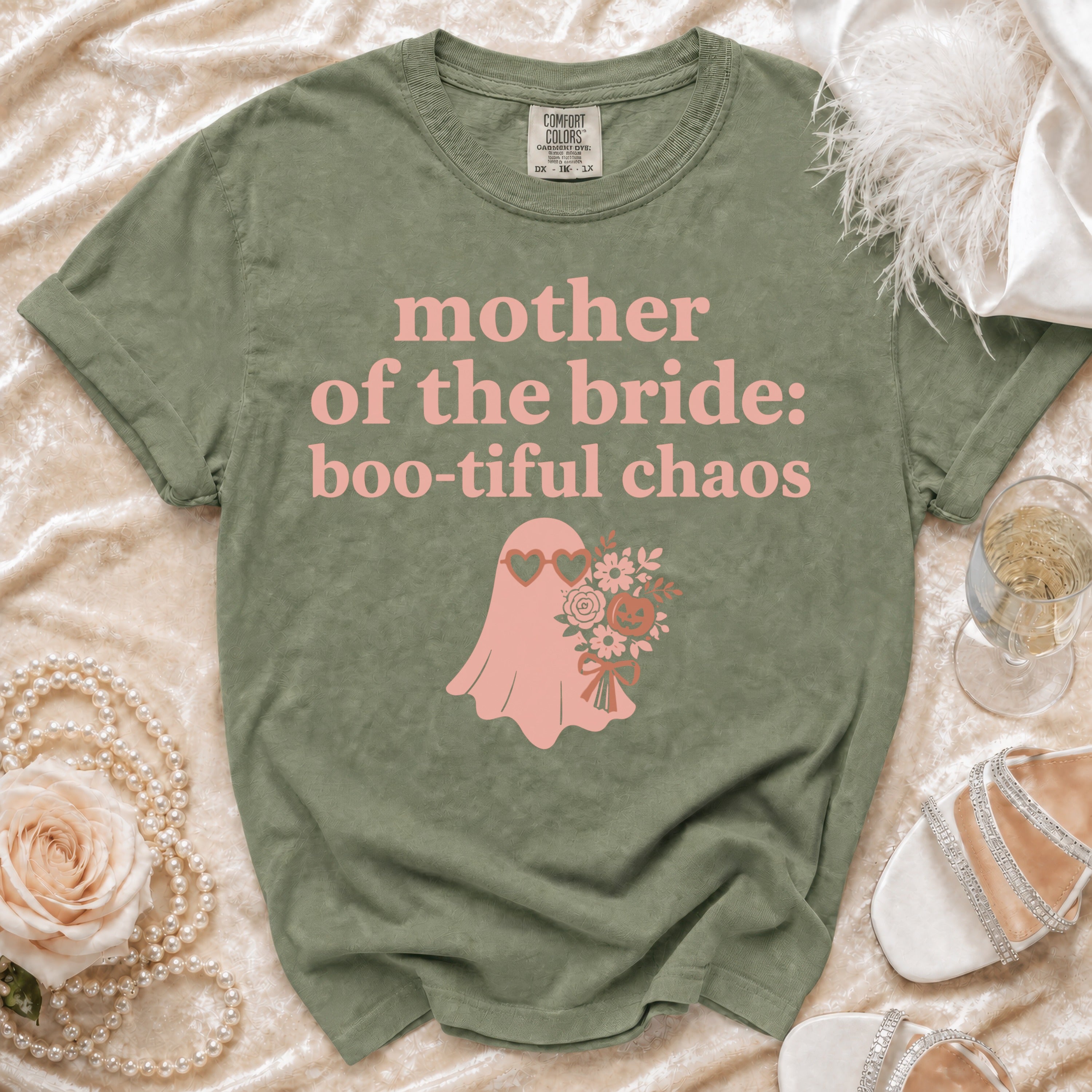 Olive green t-shirt with pink "mother of the bride: boo-tiful chaos" text and ghost graphic.