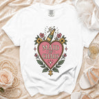 White t-shirt with "Maid of Chaos" text and champagne bottle graphic.