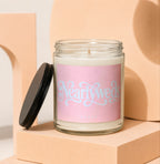 Candle with pink label saying "Nearlyweds" and "Vowed" in glass jar.