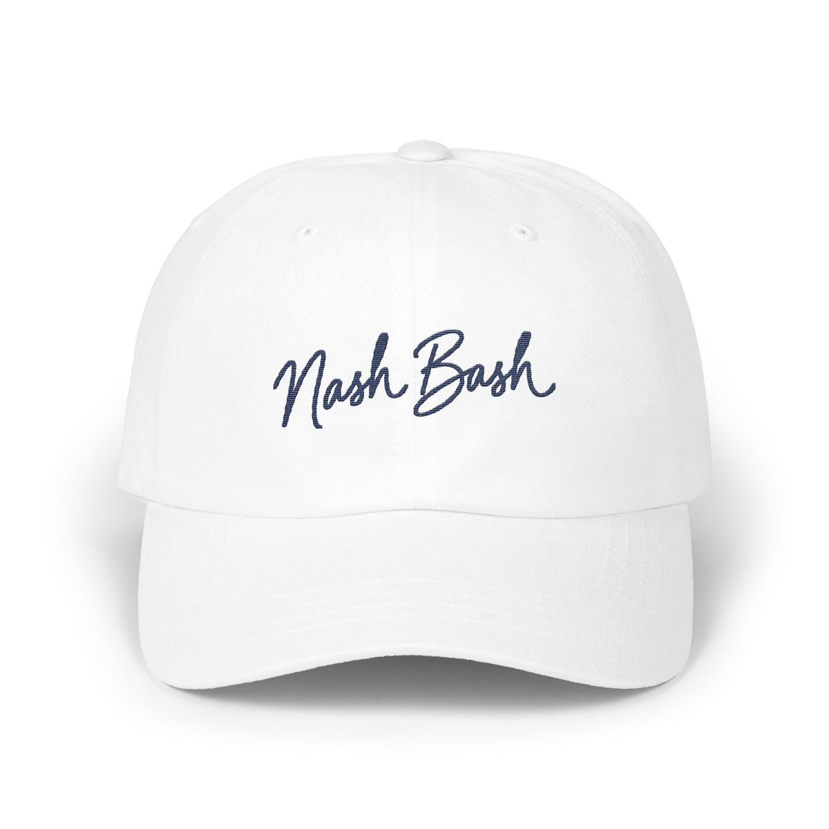 A white dad hat with embroidered navy blue script text reading Nash Bash centered on the front panels.
