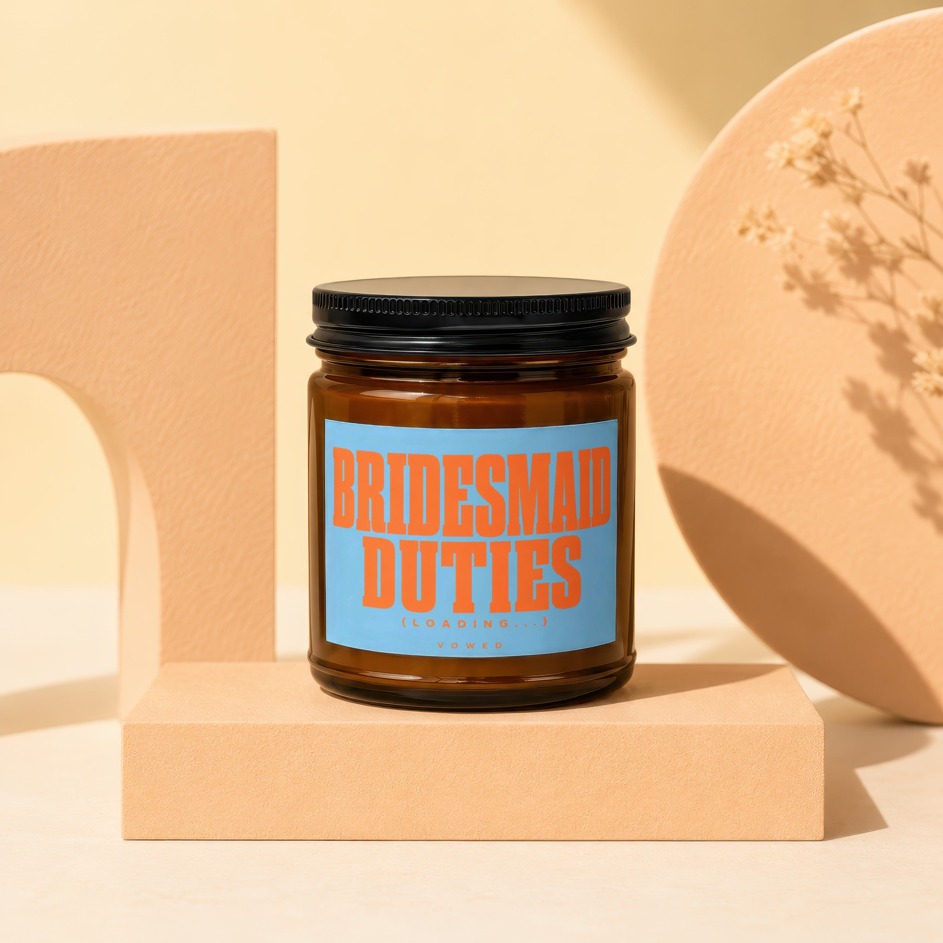 Brown glass candle with blue label reading "Bridesmaid Duties (Loading...) VOWED".