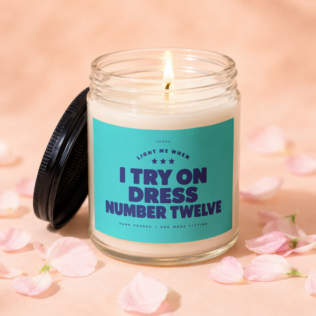 Candle with label "Light me when I try on dress number twelve."