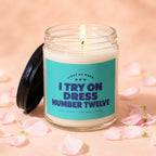 Candle with label "Light me when I try on dress number twelve."