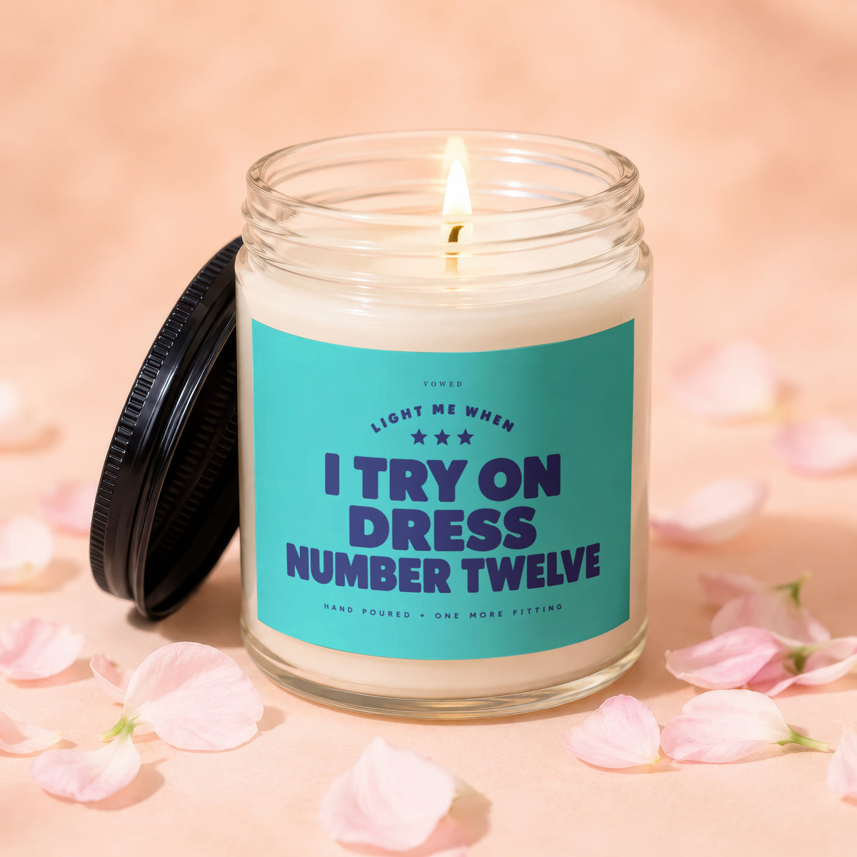 Candle with label "Light me when I try on dress number twelve."