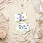 T-shirt with "Austin, TX" and "Reckless in Texas" text, featuring a cowboy boot.