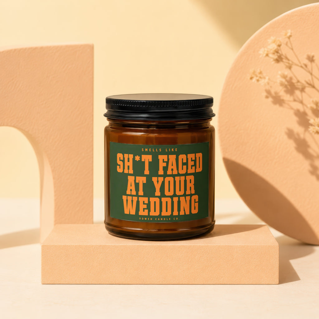 Amber candle with "Smells like sh*t faced at your wedding" text.