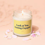 Candle with yellow label that reads "Look at You, Getting Engaged."