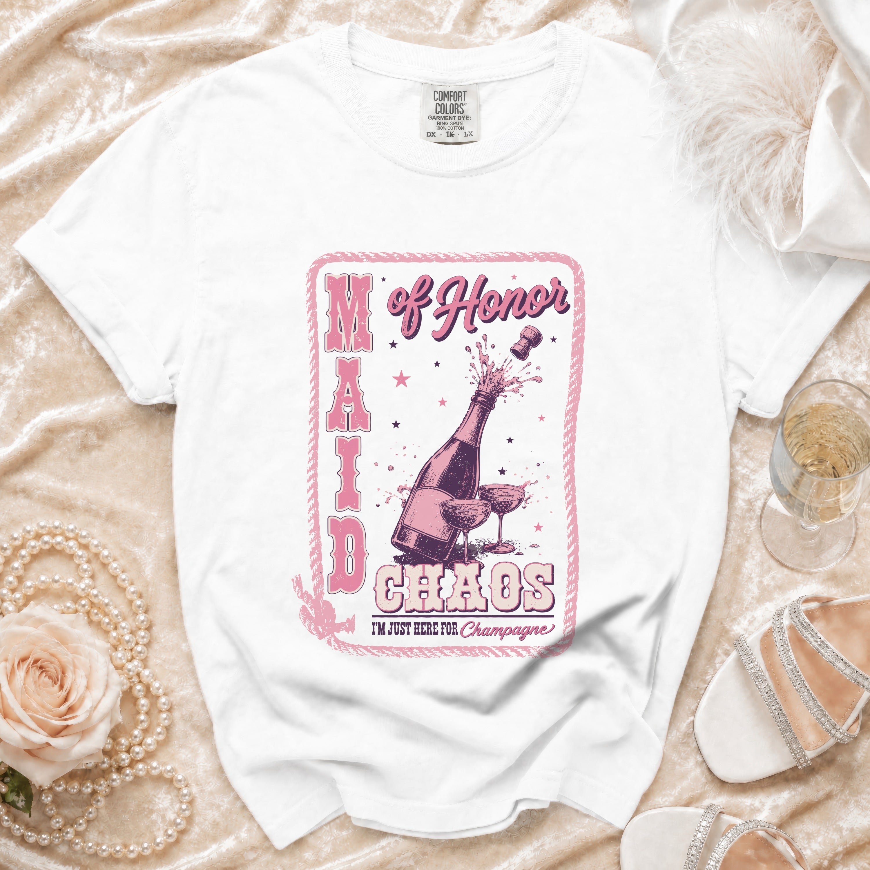 White t-shirt with "Maid of Honor Chaos I'm Just Here For Champagne" graphic.