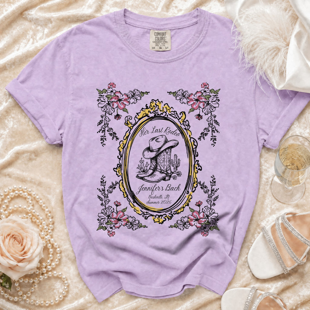 Purple t-shirt with cowboy boot, floral frame, and "Her Last Rodeo" text.