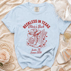 Light blue t-shirt with "Reckless in Texas" and "Olivia's Bach" graphics.