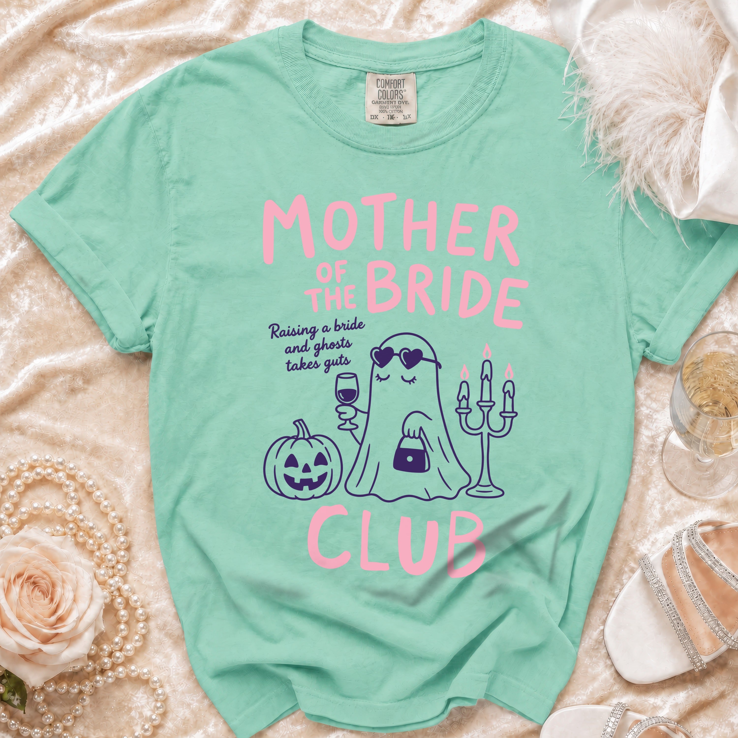 Mint green shirt with "Mother of the Bride" graphic, ghost, pumpkin, and candelabra.