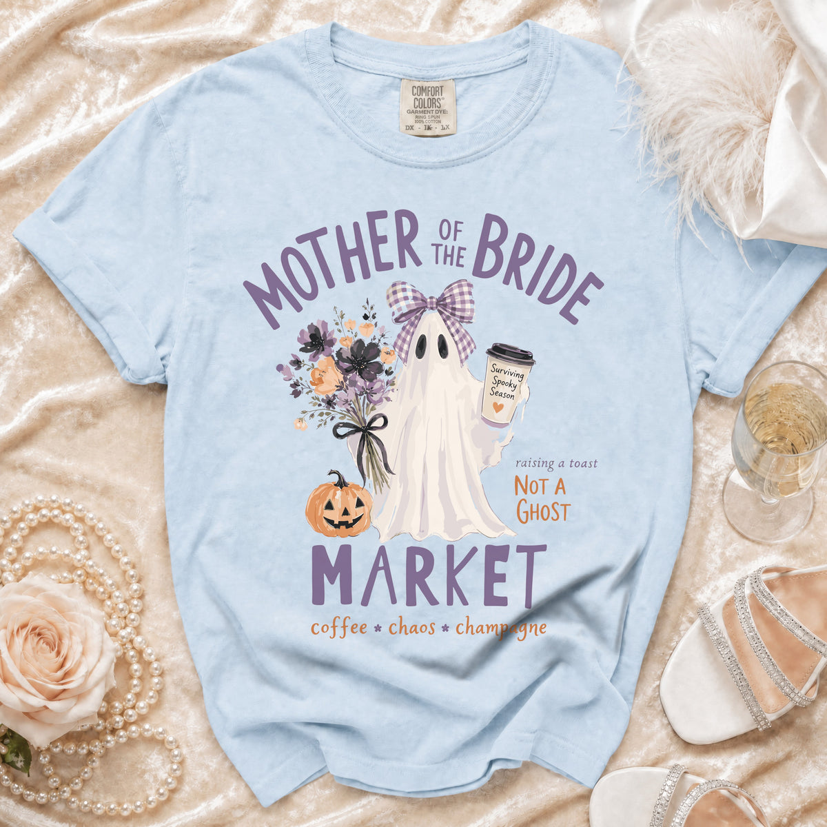 Light blue "Mother of the Bride" shirt with ghost, pumpkin, and flowers graphic.
