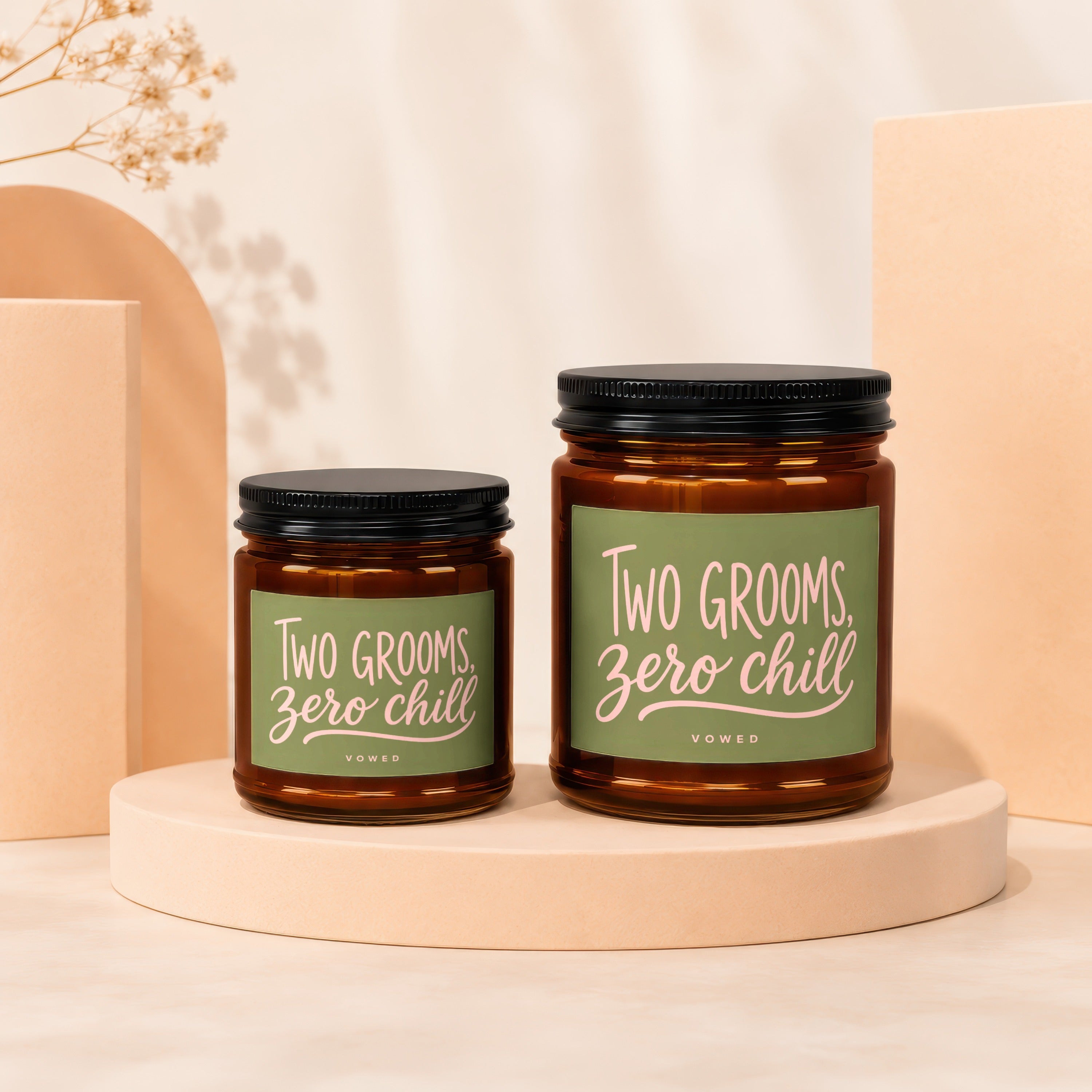 Two amber jar candles reading "Two Grooms, Zero Chill" in pastel pink text.