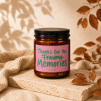 Amber candle with pink label reading "Thanks for the Trauma Memories"