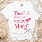 White t-shirt with pink text that says "This Girl Needs a Spicy Marg".