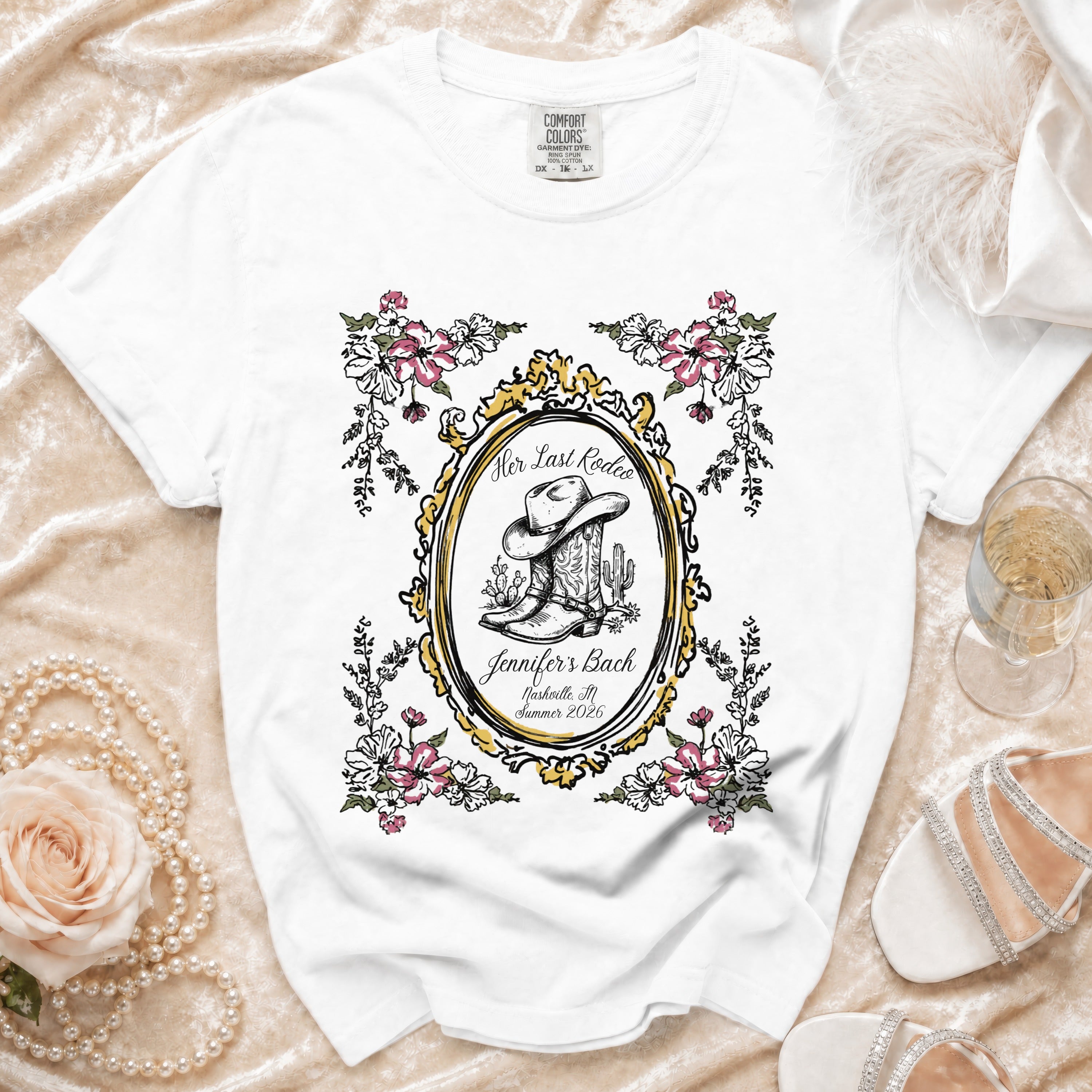 White t-shirt with "Her Last Rodeo" and bachelorette details in an oval frame.