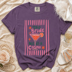Purple t-shirt with graphic: "This Bride Needs a Cosmo" and cocktail art.
